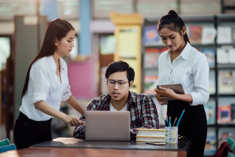 Young students learning,library bookshelves on background